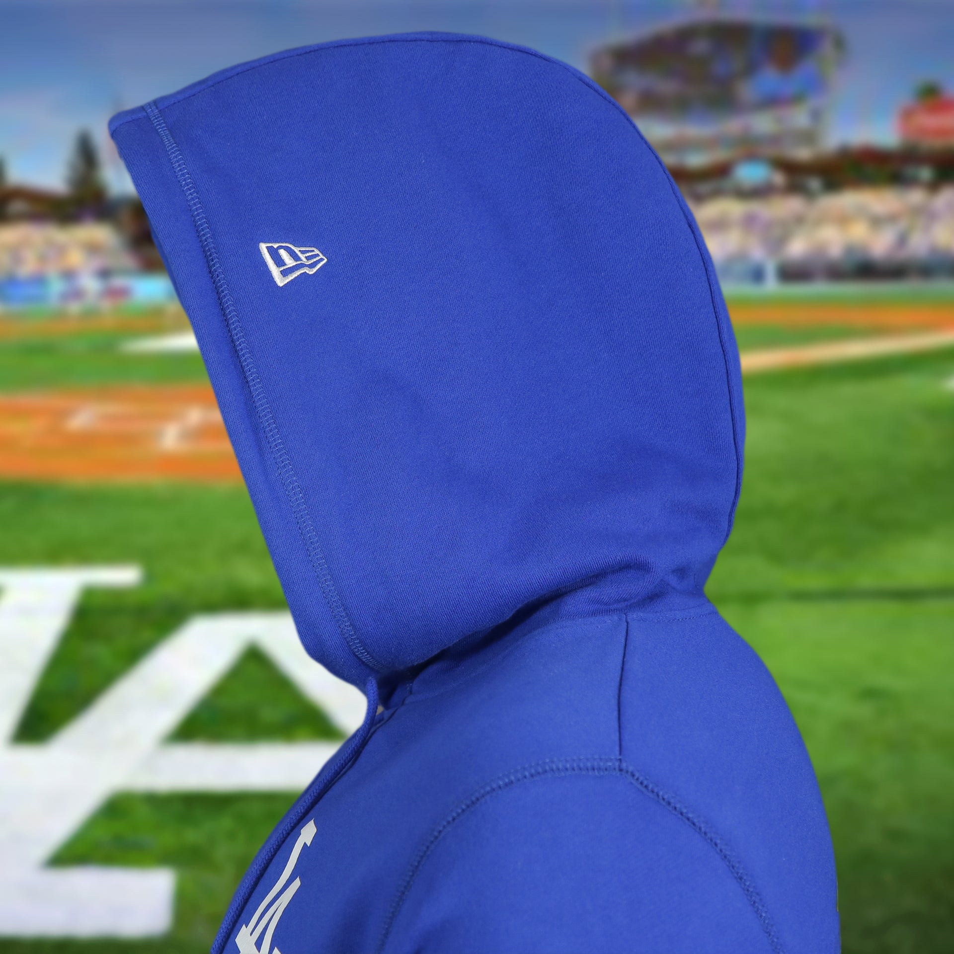 hood of the Los Angeles Dodgers "City Cluster" 59Fifty Fitted Matching Royal Pullover Hoodie