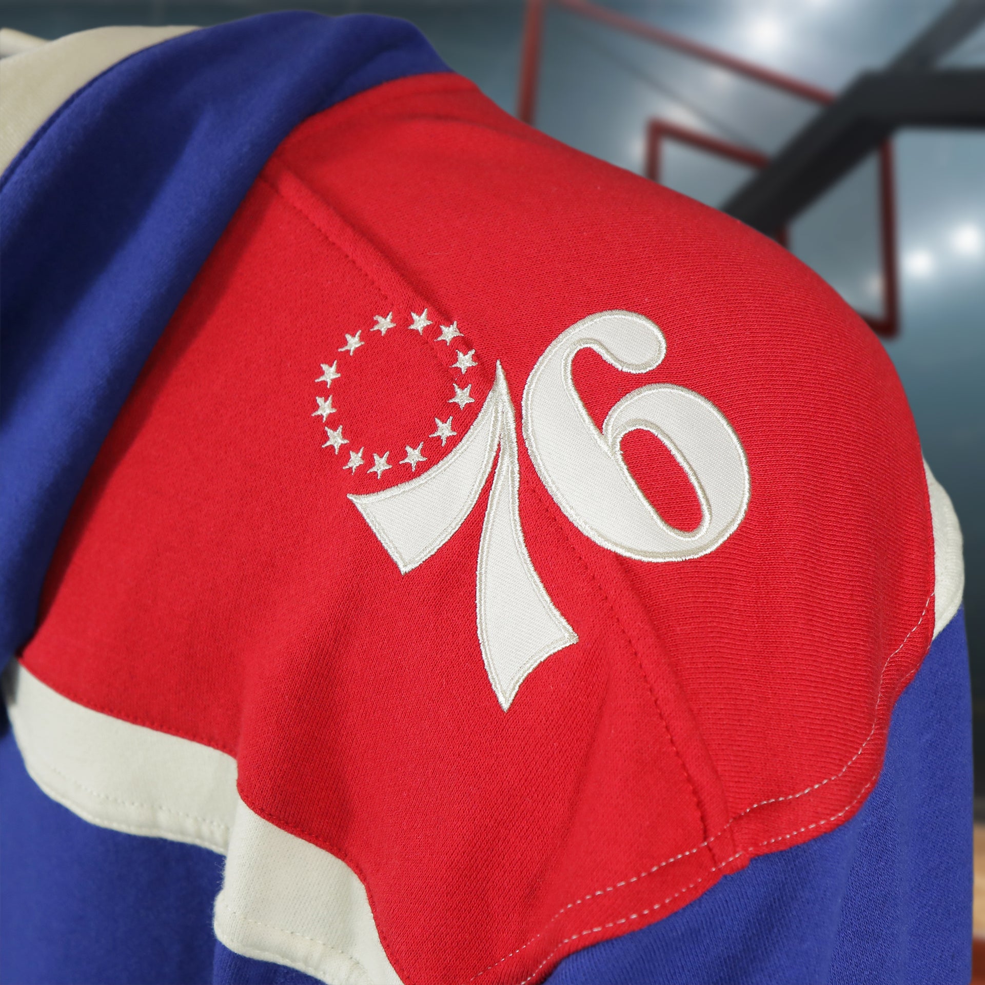 76ers logo on wearers left on the Philadelphia 76ers Vintage Hockey 47 Lacer Hoodie |  Blue, Red, White