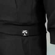 bonsai tree logo on the Jet Black Unbasic Fleece Stash Pocket Sunset Park Tapered Zipper Hoodie | Fleece Black Hoodie