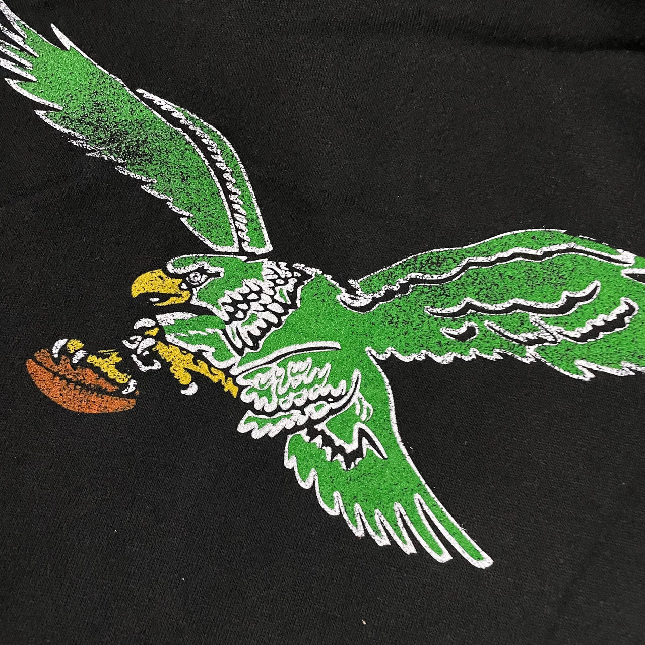 close up of front logo for Philadelphia Eagles Throwback Bird Kelly Green Logo Imprint Jet Black Men's Pullover Hoodie