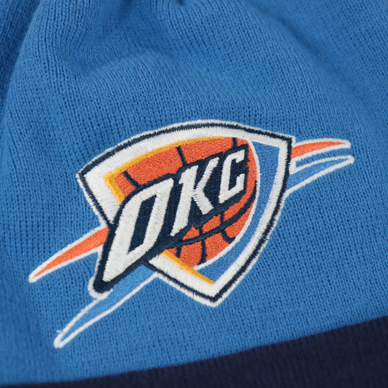 thunders logo on the Oklahoma City Thunder Mitchell and Ness Winter Pom Beanie