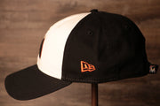 The wearers left side is black with the new era logo Marlins Dad Hat | Miami Marlins Retro Baseball Cap