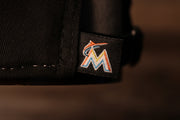 The marlins logo is on a tag on the back of the hat Marlins Dad Hat | Miami Marlins Retro Baseball Cap