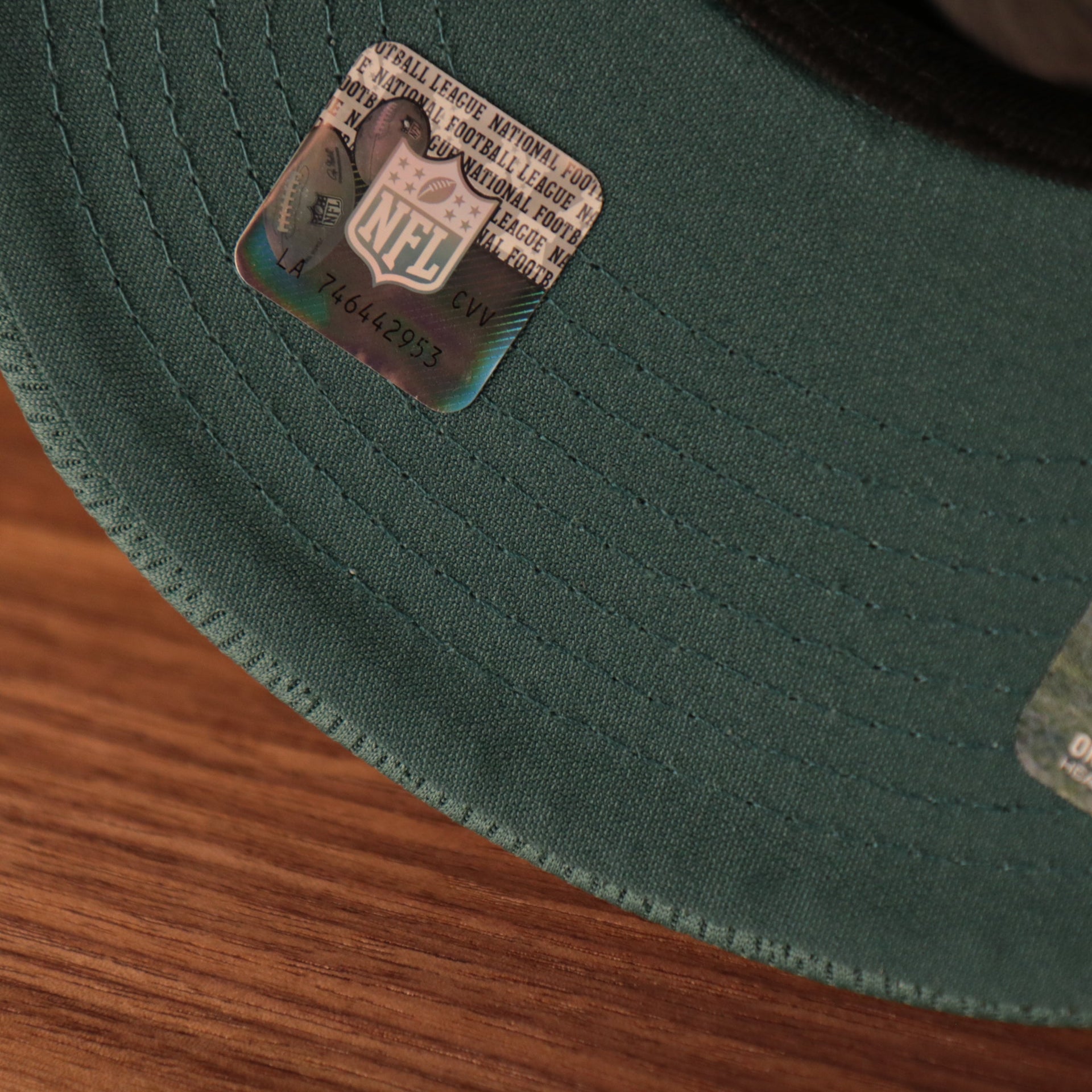 A closeup shot of the midnight green underbrim at the bottom of the 2021 nfl on field snapback hat.
