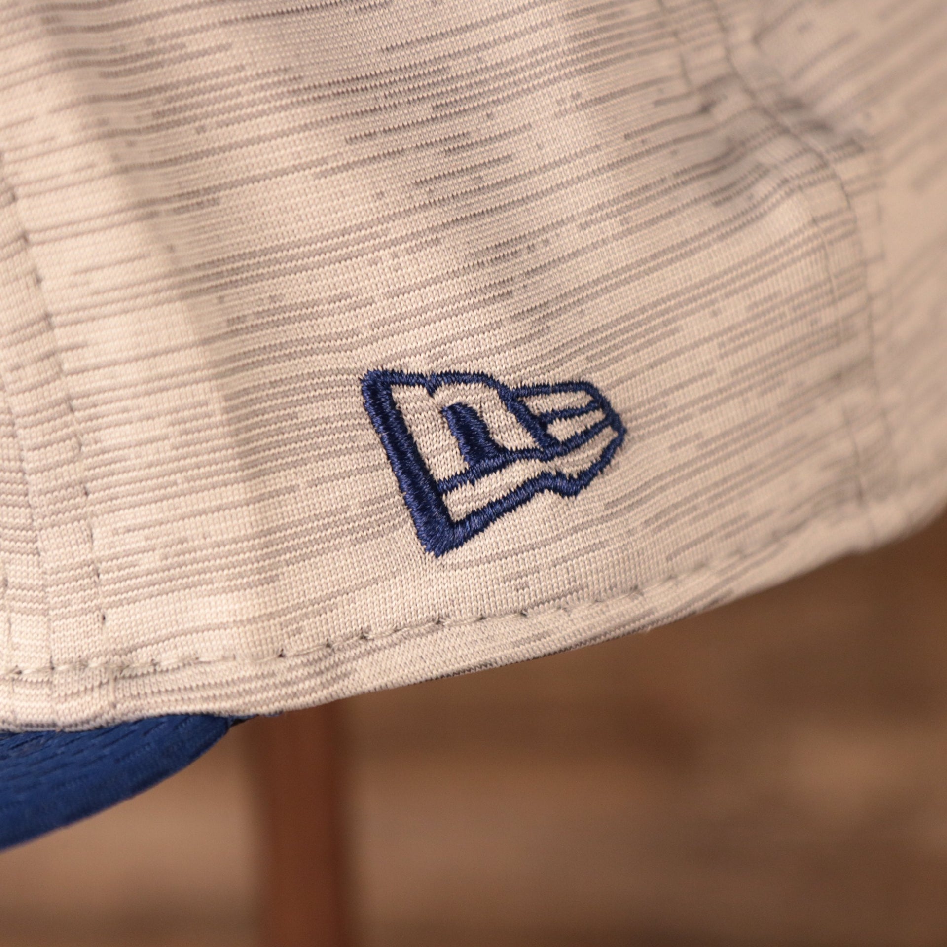 A closeup shot of the New Era royal blue patch on the side of the 2021 nfl on field snapback hat.
