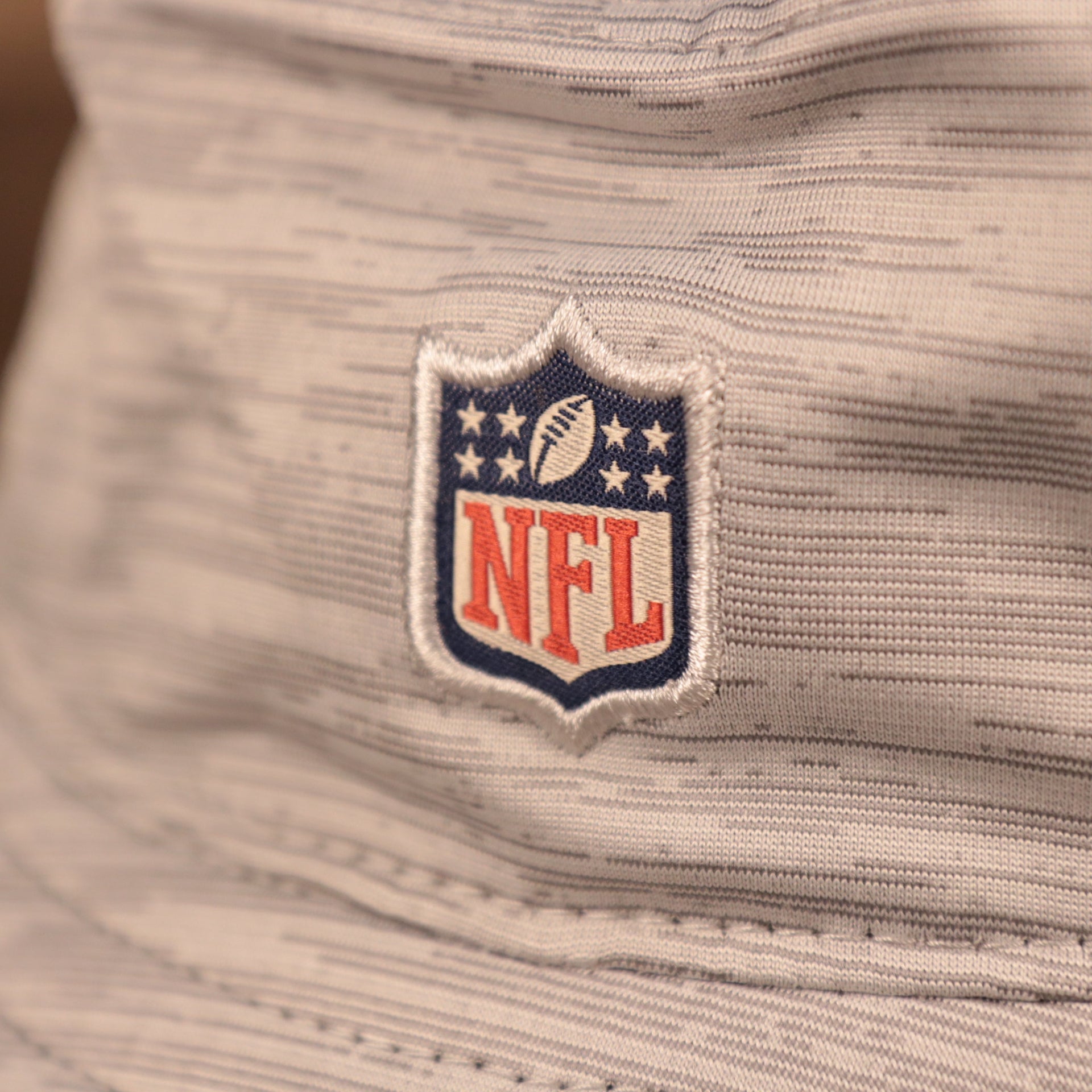 A closeup shot of the NFL patch on the back of the atlanta falcons 2021 nfl on field bucket hat.
