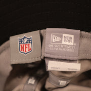 The NFL and new era tag on the inside of the gray Atlanta Falcons 2021 nfl training bucket hat by New Era.