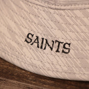 A closeup shot of the Saints patch on the side of the gray 2021 nfl training bucket hat by New Era.