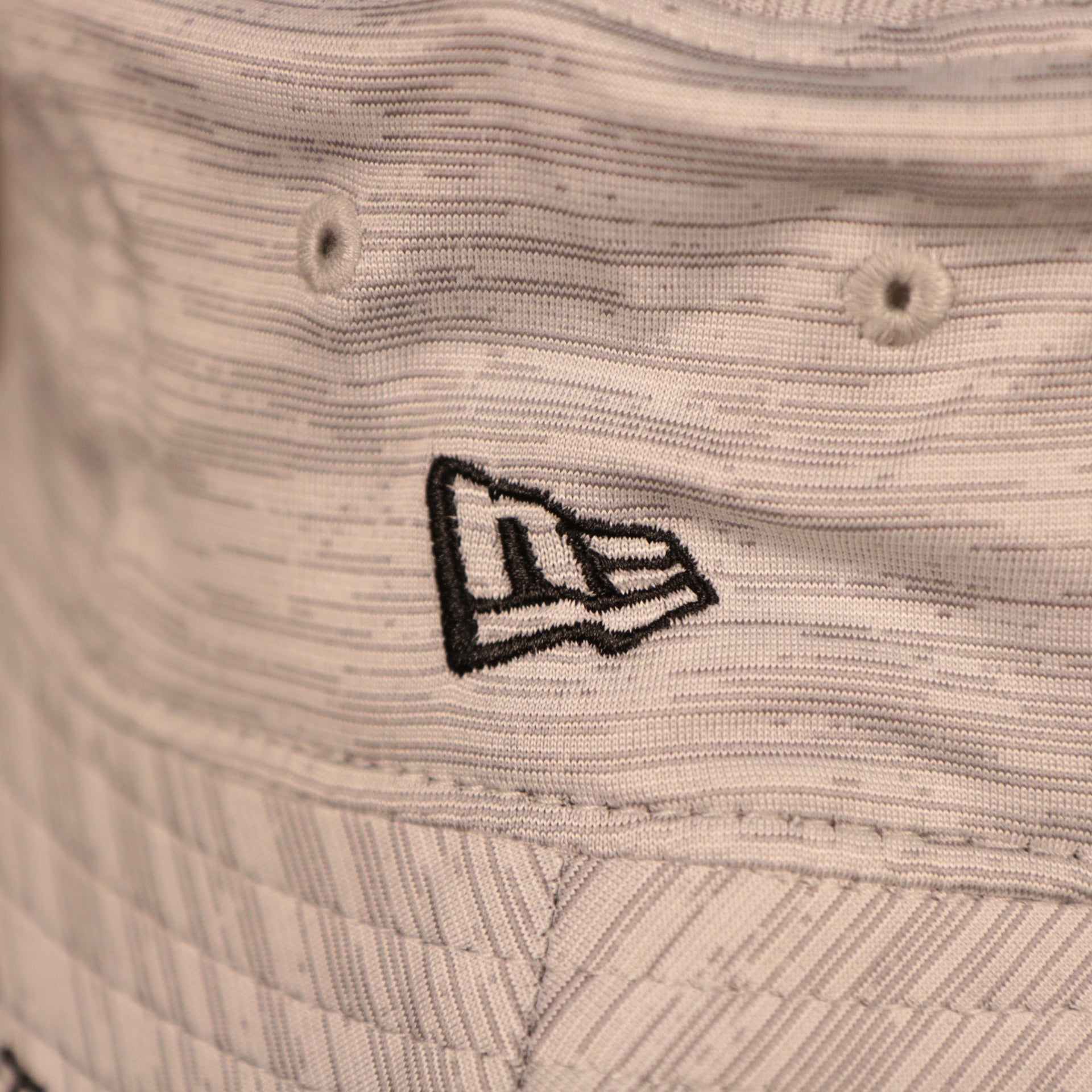 A closeup shot of the New Era patch on the side of the 2021 nfl on field bucket hat.