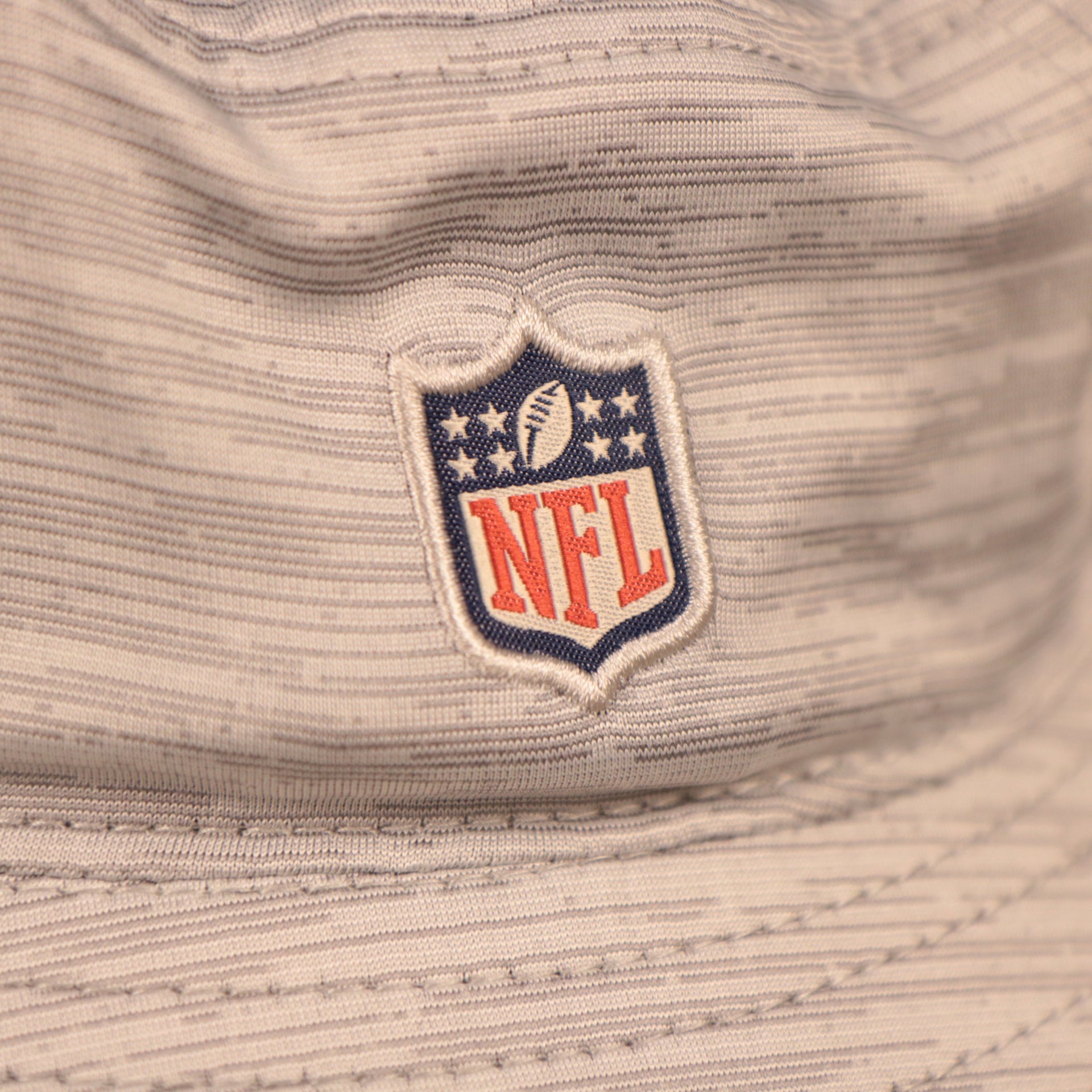 A closeup shot of the NFL patch at the back of the new era training 2021 bucket hat..