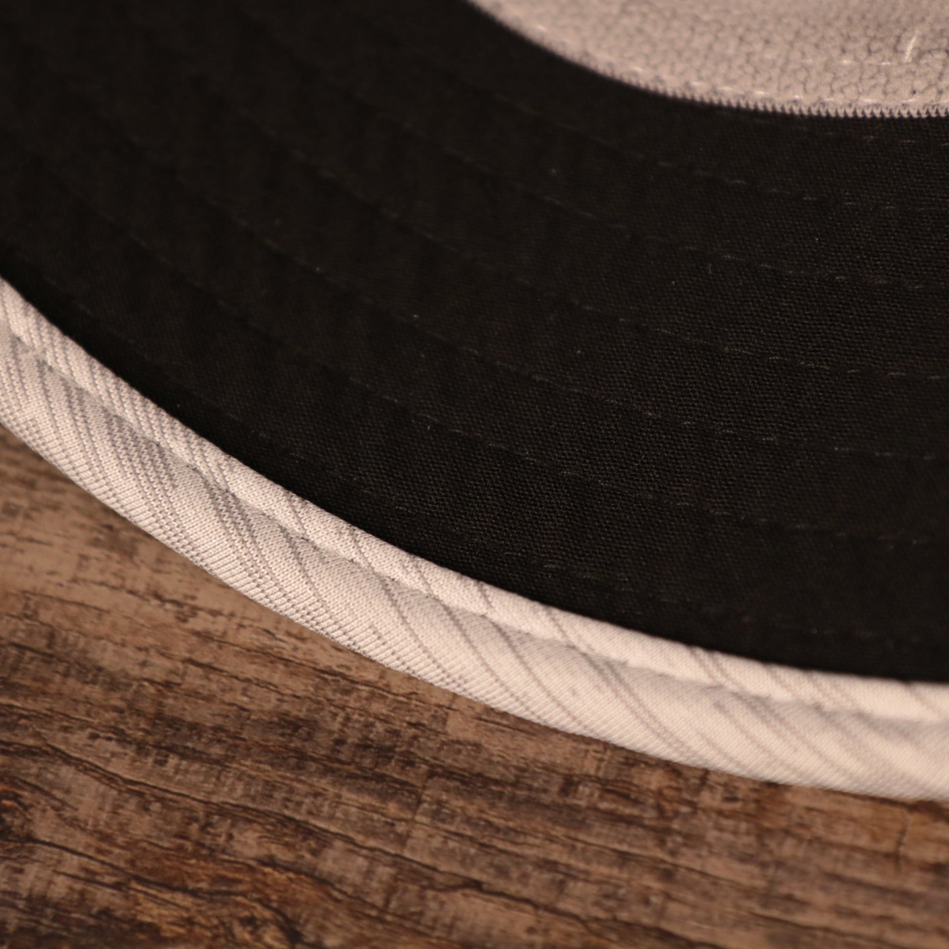 A closeup shot of the underbrim of the gray nfl training hats bucket hat by New Era.