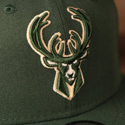 bucks logo on the front of the Milwaukee Bucks 2021 NBA Playoffs 9Fifty Gray Bottom Side Patch Snapback Hat