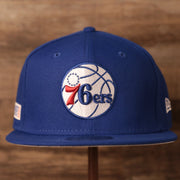 front of the Philadelphia 76ers 2021 NBA Playoffs Royal Blue 9Fifty Gray Bottom Snapback Hat