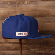 wearers right side of the Philadelphia 76ers 2021 NBA Playoffs Royal Blue 9Fifty Gray Bottom Snapback Hat