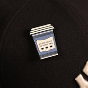 A close up of the New York Coffee Cup We Are Happy To Serve Fitted Cap Pin | Enamel Pin For Hat