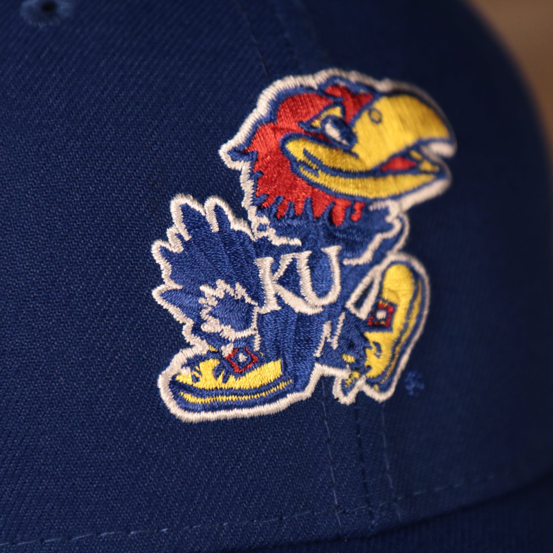 Close up of the Jayhawks logo embroidered on the front of the Kansas Jayhawks The League 940 9Forty Adjustable Dad Hat