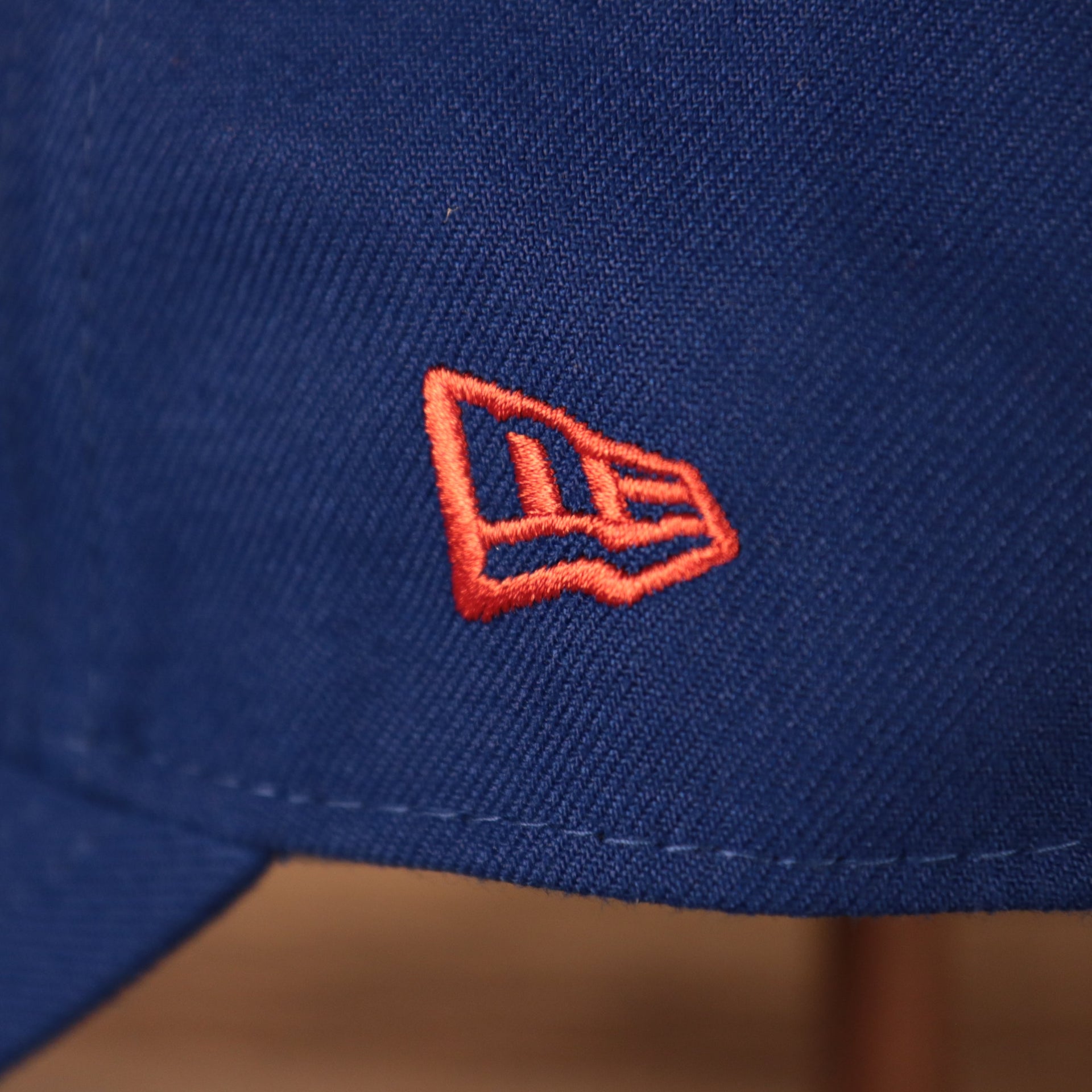 Close up of the New Era logo embroidered on the wearer's left of the Kansas Jayhawks The League 940 9Forty Adjustable Dad Hat