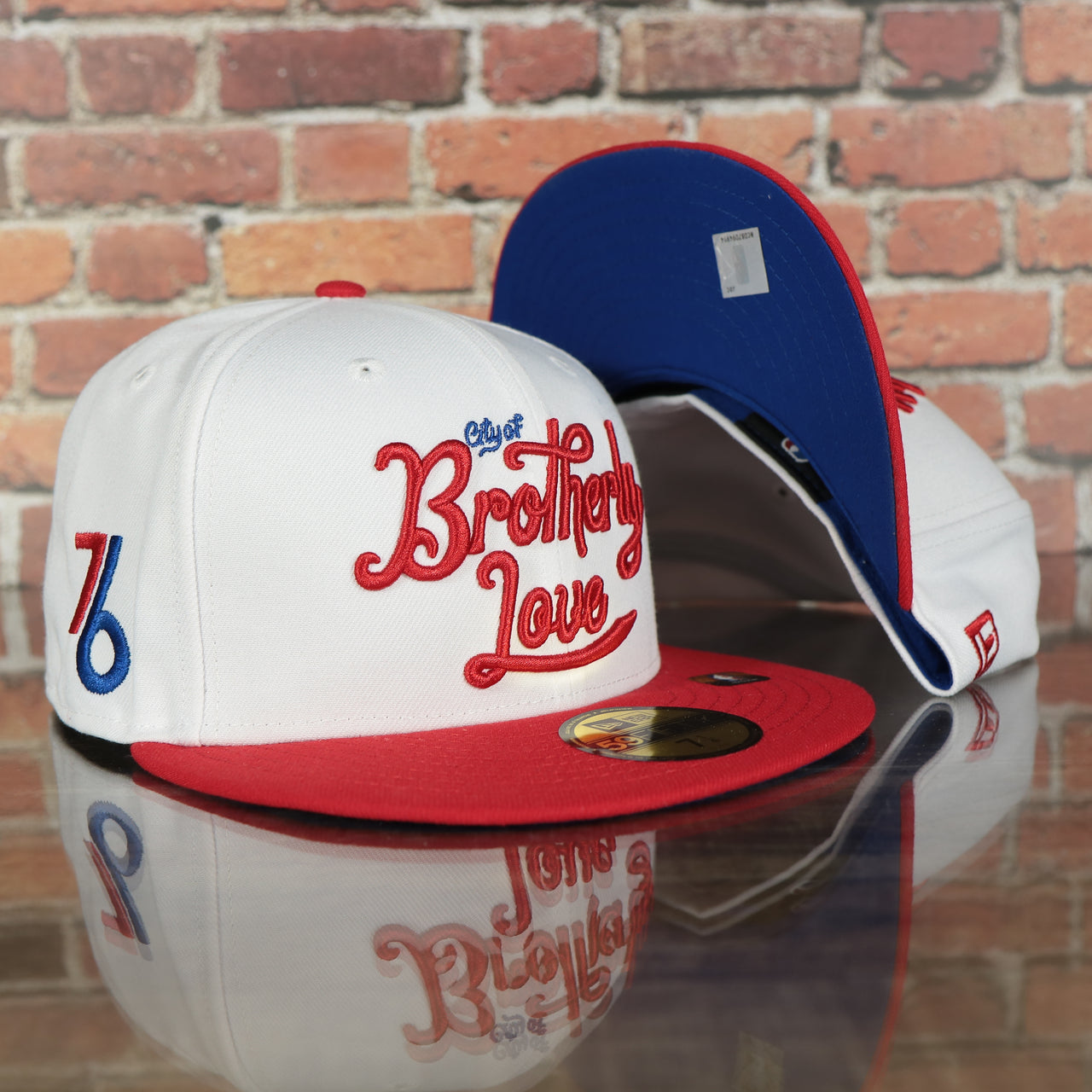 front and bottom of the Philadelphia 76ers 2022 City Edition City Of Brotherly Love Blue Bottom 59Fifty Side Patch Fitted Cap | New Era, White