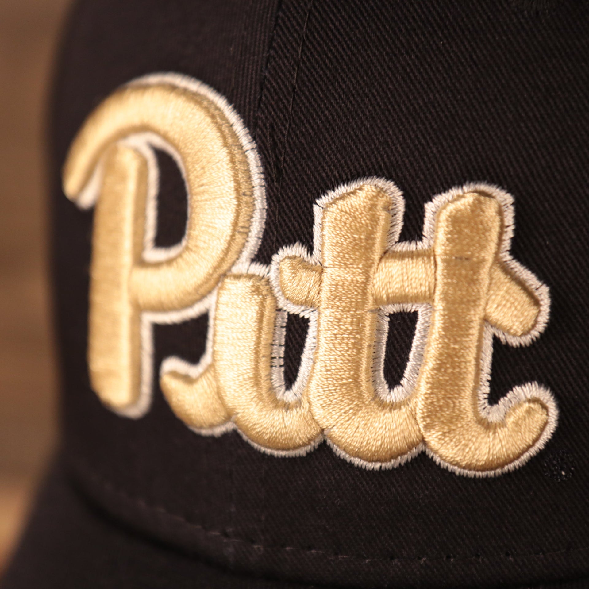 Close up of the Pitt wordmark logo embroidered on the front of the Pittsburgh Panthers The League 940 9Forty Adjustable Dad Hat