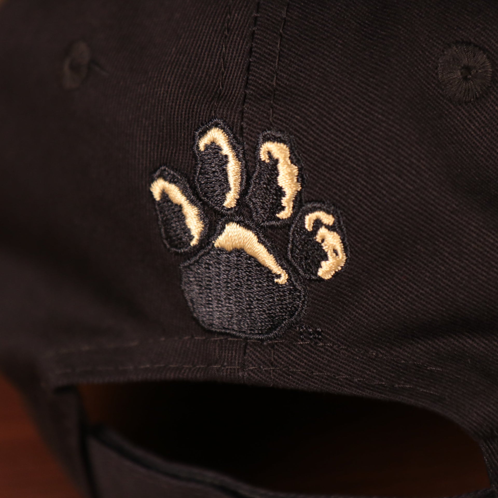 Close up of the paw print logo embroidered on the back of the Pittsburgh Panthers The League 940 9Forty Adjustable Dad Hat
