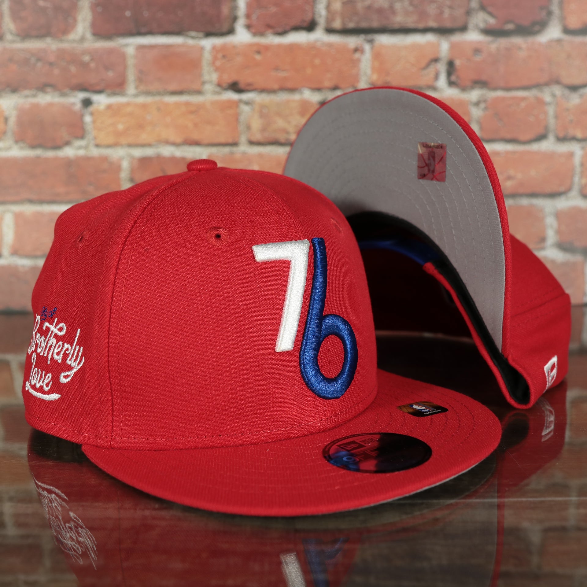 front and bottom of the Philadelphia 76ers 2022 City Edition Vintage 76 Logo Gray Bottom Youth 9Fifty Side Patch Snapback Cap | New Era, Red