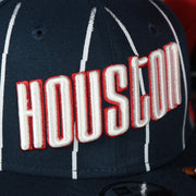 houston city logo on the front side of the Houston Rockets 2022 City Edition Retro Houston Red Bottom Youth 9Fifty Side Patch Snapback Cap | New Era, Navy