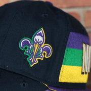 pelicans logo on the wearers right side of the New Orleans Pelicans 2022 City Edition NOLA Logo Yellow Bottom Youth 9Fifty Side Patch Snapback Cap | New Era, Navy