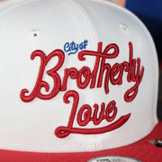 city of brotherly love city edition logo on the front of the Philadelphia 76ers 2022 City Edition City Of Brotherly Love Blue Bottom Youth 9Fifty Side Patch Snapback Cap | New Era, White