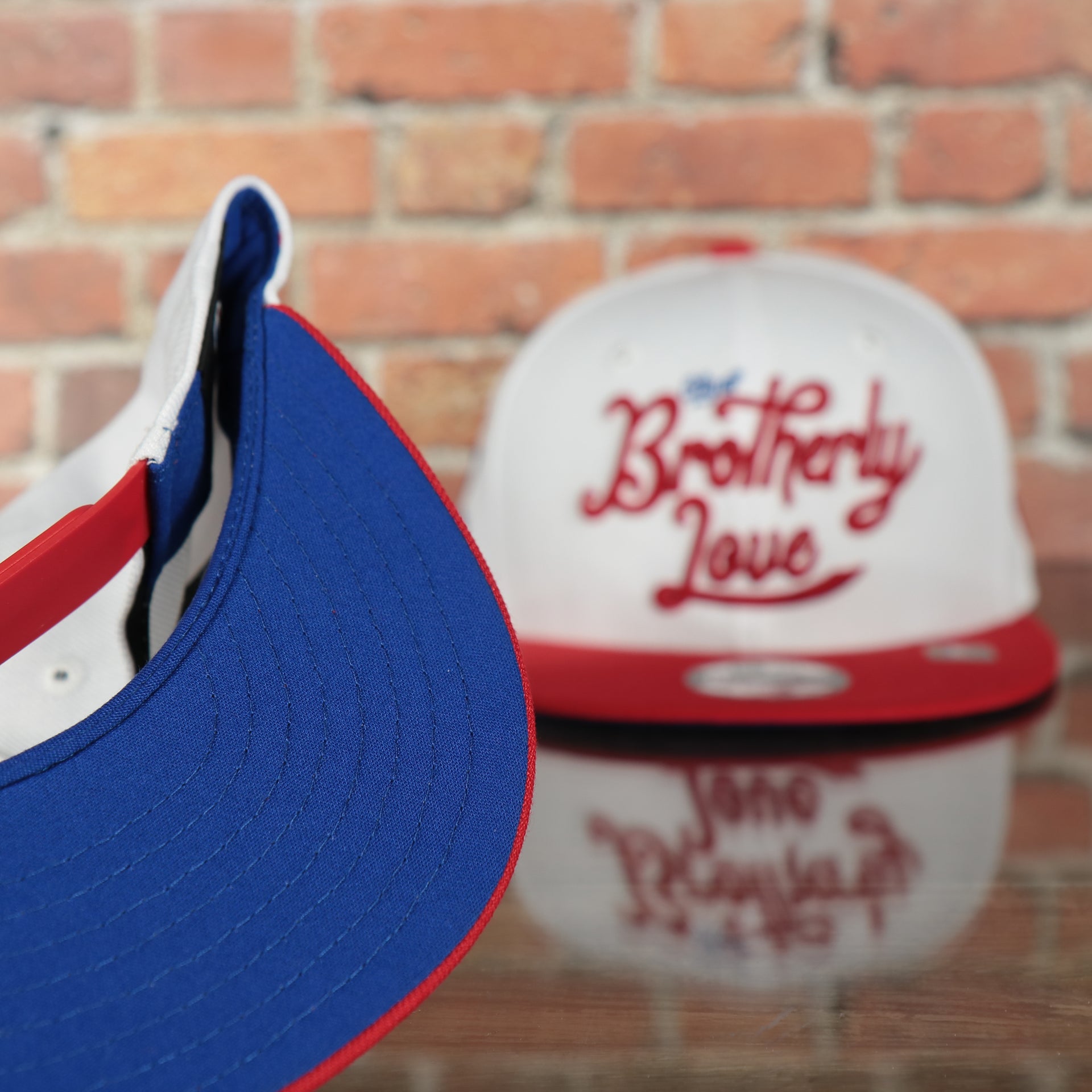 under side of the Philadelphia 76ers 2022 City Edition City Of Brotherly Love Blue Bottom Youth 9Fifty Side Patch Snapback Cap | New Era, White