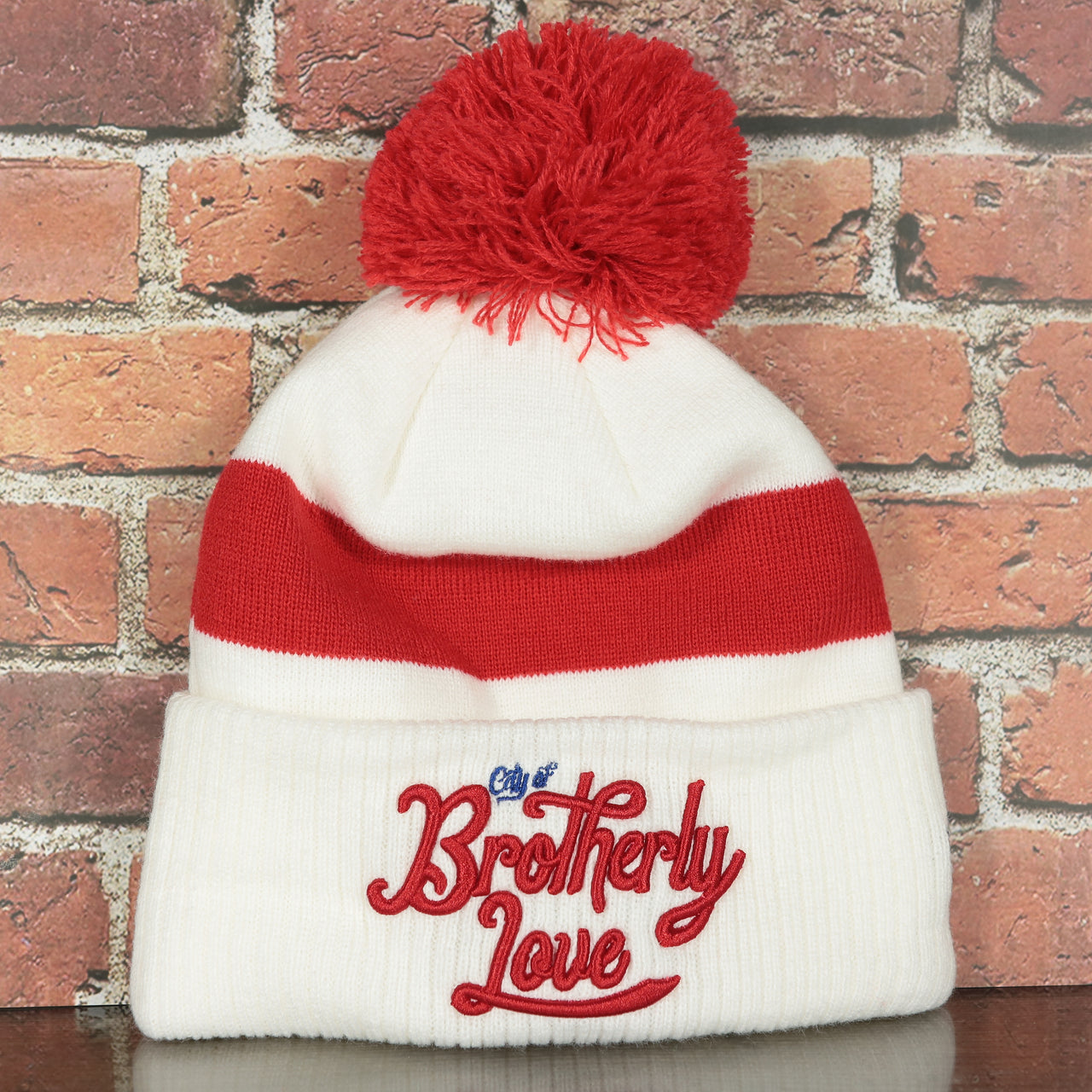 front side of the Philadelphia 76ers 2022 City Edition City Of Brotherly Love Youth Beanie | New Era, White