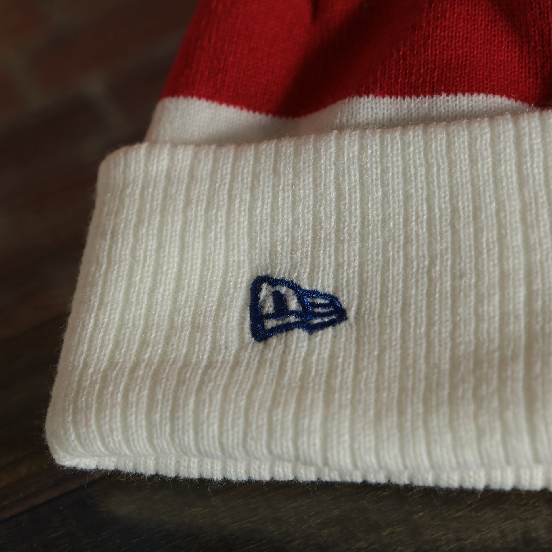 new era log on the cuff of the wearers left side of the Philadelphia 76ers 2022 City Edition City Of Brotherly Love Youth Beanie | New Era, White
