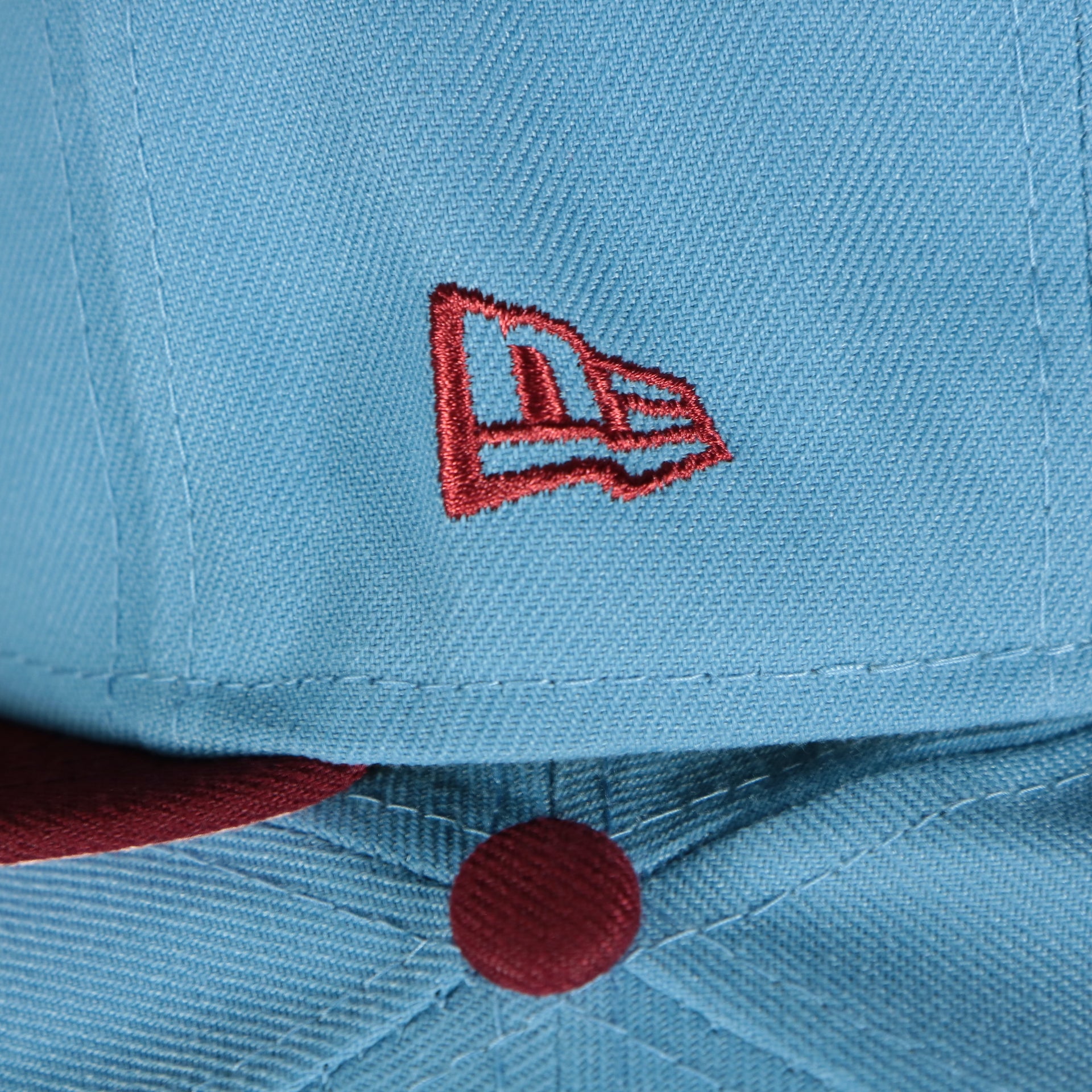Close up of the New Era flag and button on the Philadelphia Phillies 2008 World Series Side Patch Cooperstown Pink Bottom 59Fifty Fitted Cap | Sky Blue