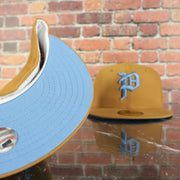 sky blue under visor on the Philadelphia Phillies Cooperstown 1910 Logo 100th Anniversary Side Patch Icy Blue UV 59Fifty Fitted Cap | "English Toffee" Hoagie Pack