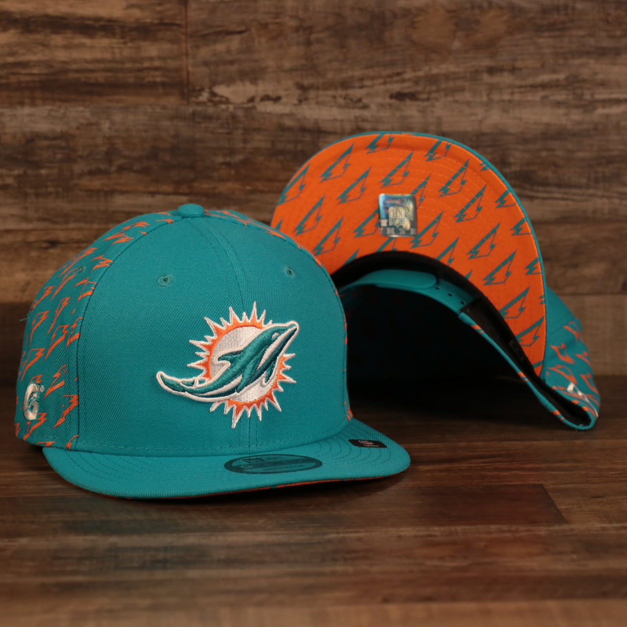 front and bottom of the Miami Dolphins x Gatorade Red 9Fifty Grey Bottom Snapback