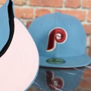 pink under visor on the Philadelphia Phillies 1980 World Series Glow In The Dark Pink Brim 59fifty Fitted Cap | Sky Blue