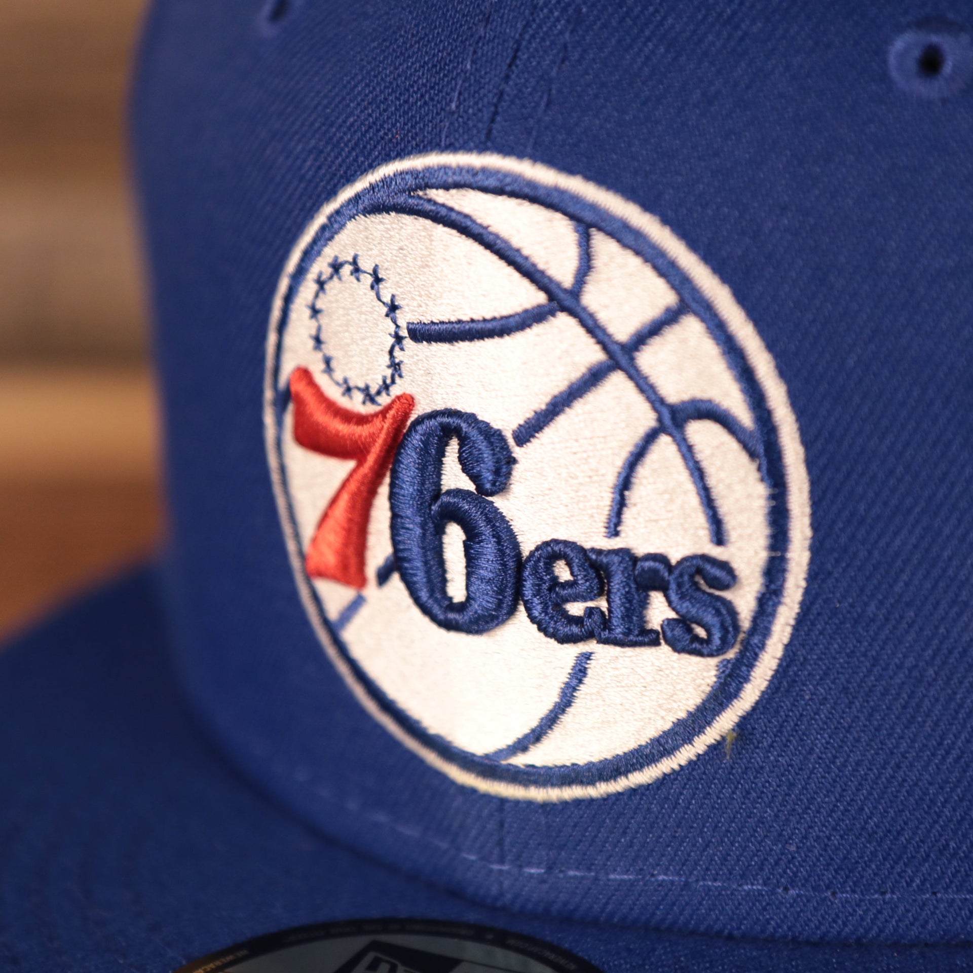 76ers logo on the Philadelphia 76ers Grey Bottom | Royal Blue 59Fifty Fitted Cap