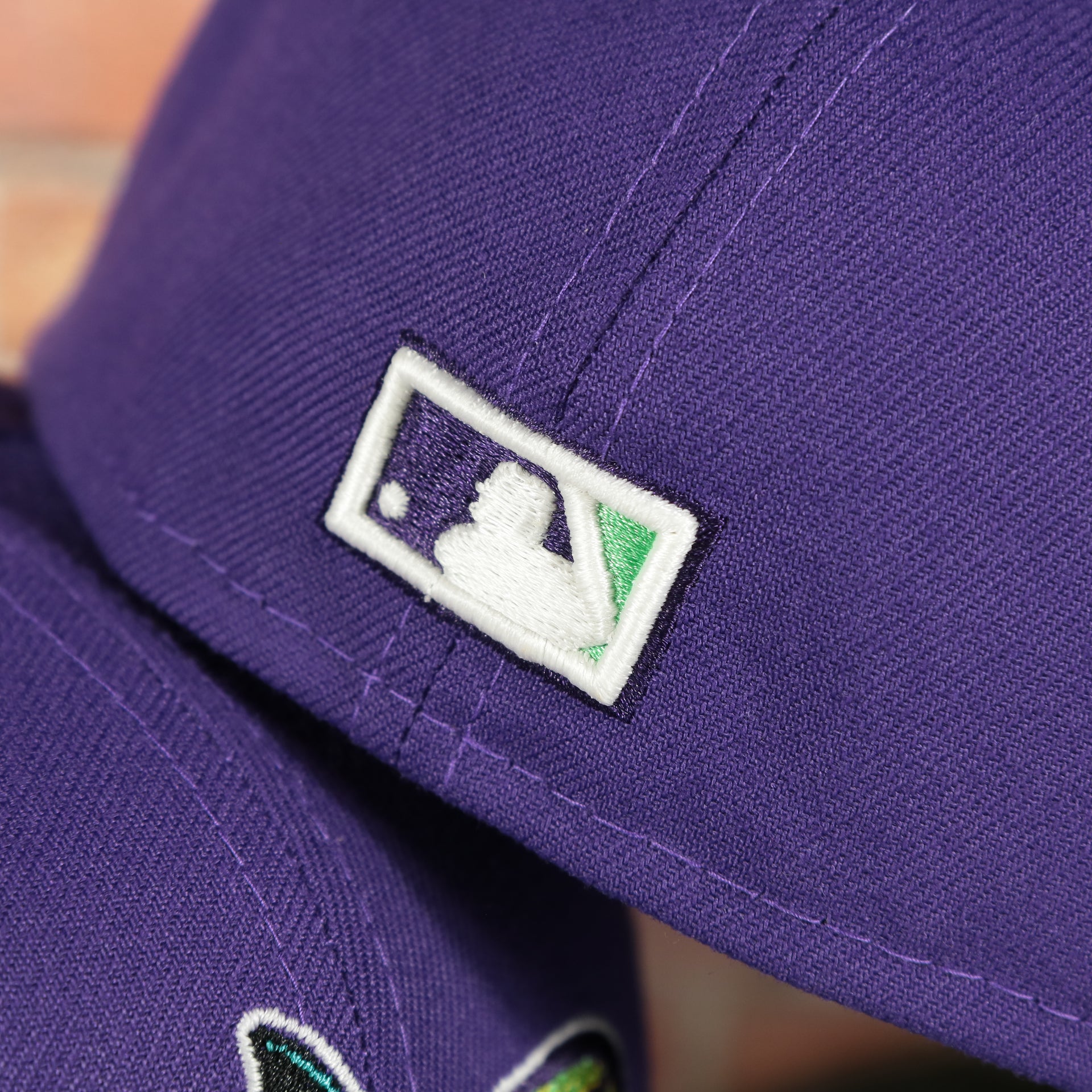 coopestown batterman logo on the Tampa Bay Devil Rays 1998 Inaugural Season Side Patch Purple 59Fifty Green Bottom Fitted Cap | Donatello Pack