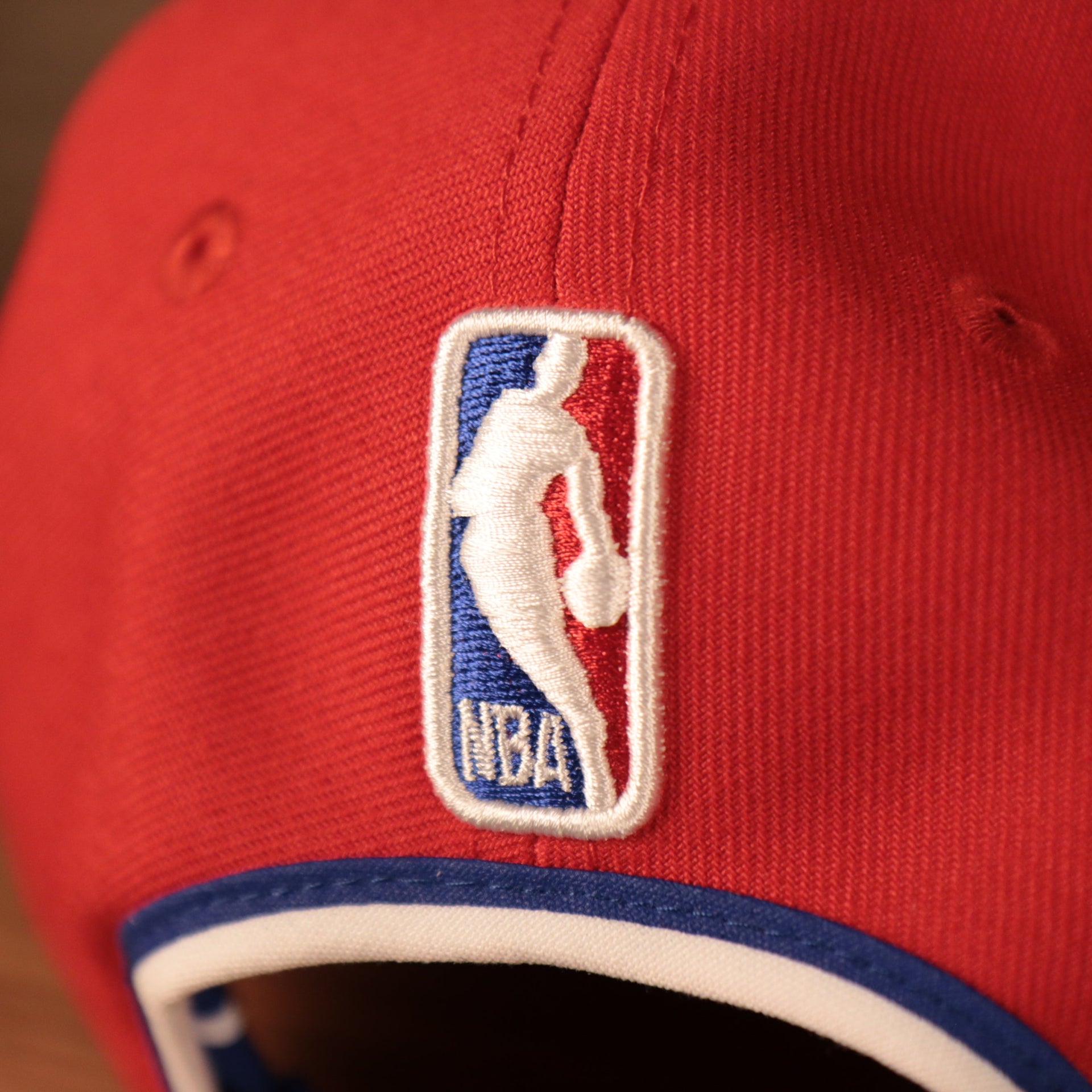 Close up of the NBA logo on the back of the Philadelphia 76ers Phila Script Side Patch 940 9Forty Dad Hat