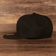 Wearer's left of the Philadelphia Phillies Black on Black Tonal Grey Bottom 9Fifty Snapback Hat