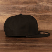 Wearer's right of the Philadelphia Phillies Black on Black Tonal Grey Bottom 9Fifty Snapback Hat