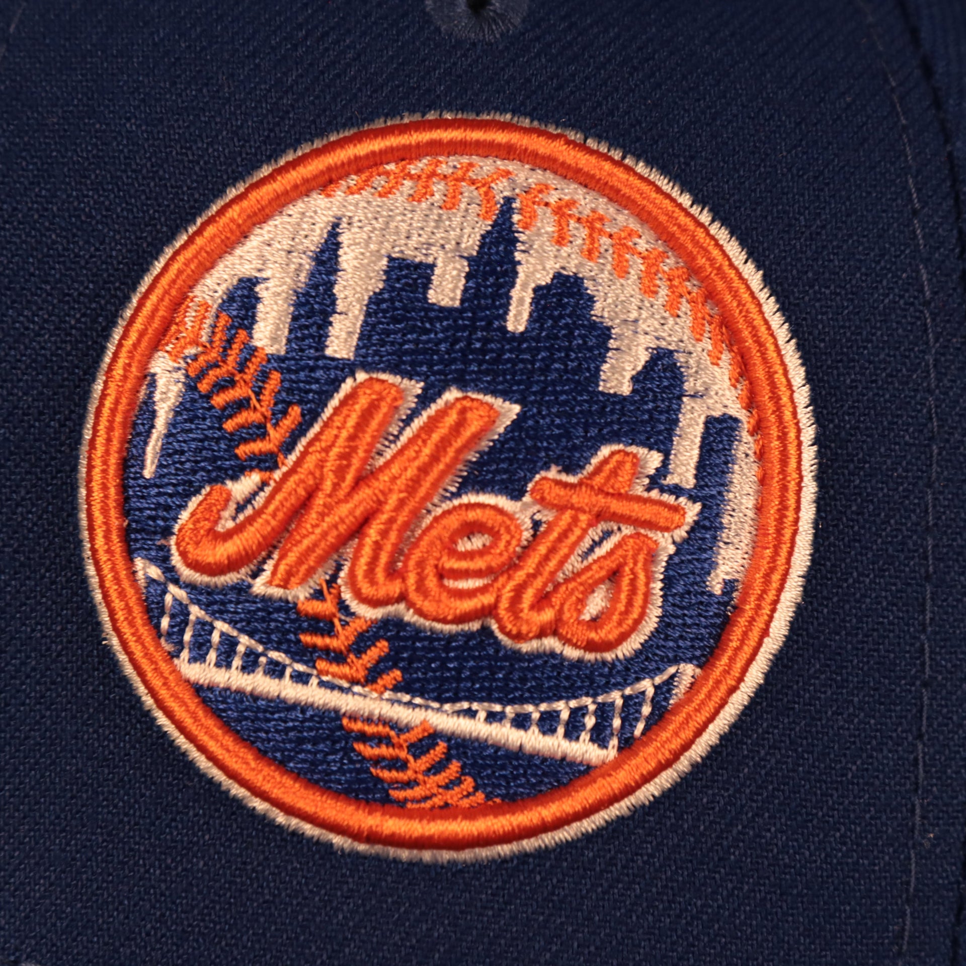 Close up of the Mets Wordmark Logo on the New York Mets "Patch Pride" All Over Gray Bottom Side Patch 59Fifty Fitted Cap