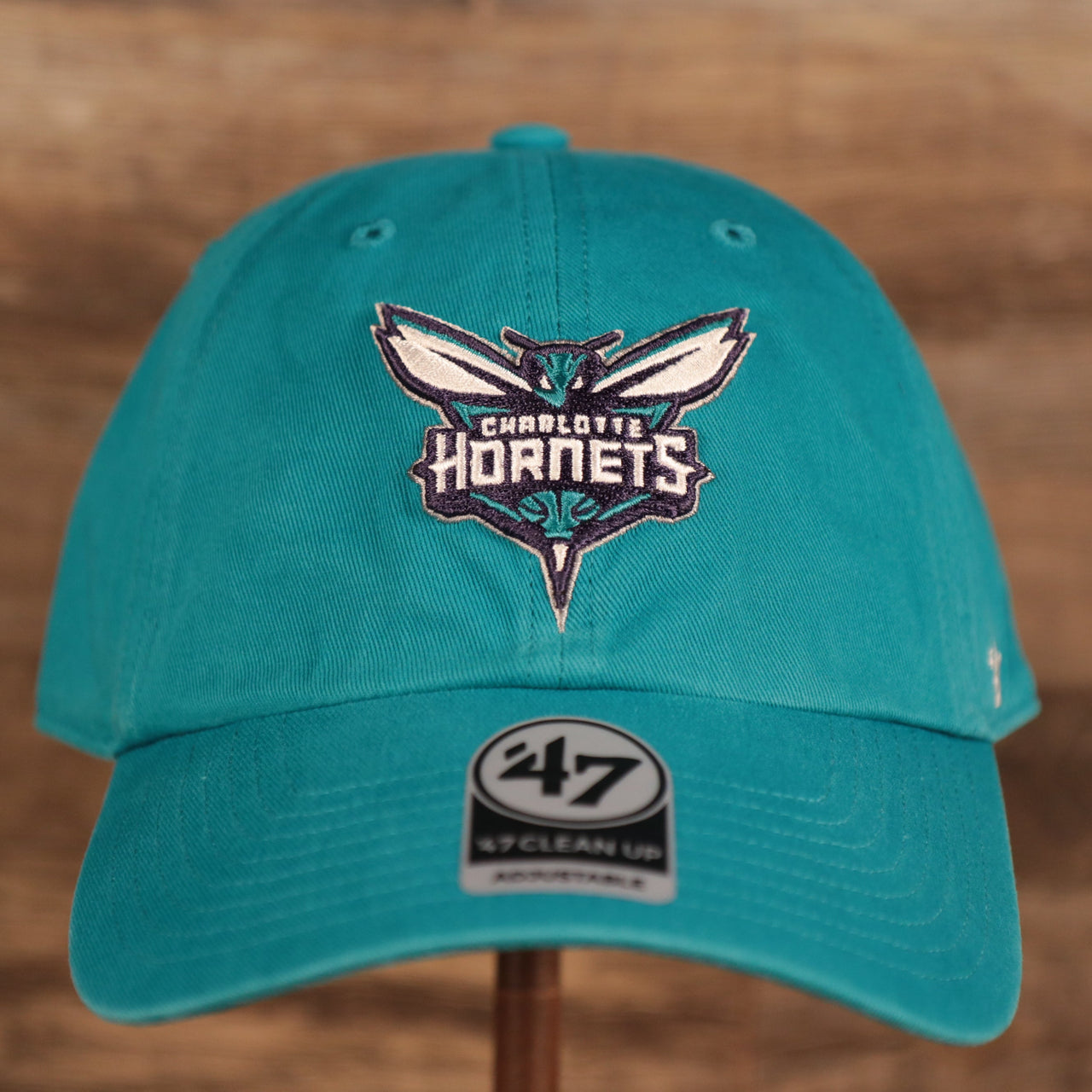 front of the Charlotte Hornets Cyan Adjustable Dad Hat