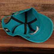 bottom view of the Charlotte Hornets Cyan Adjustable Dad Hat