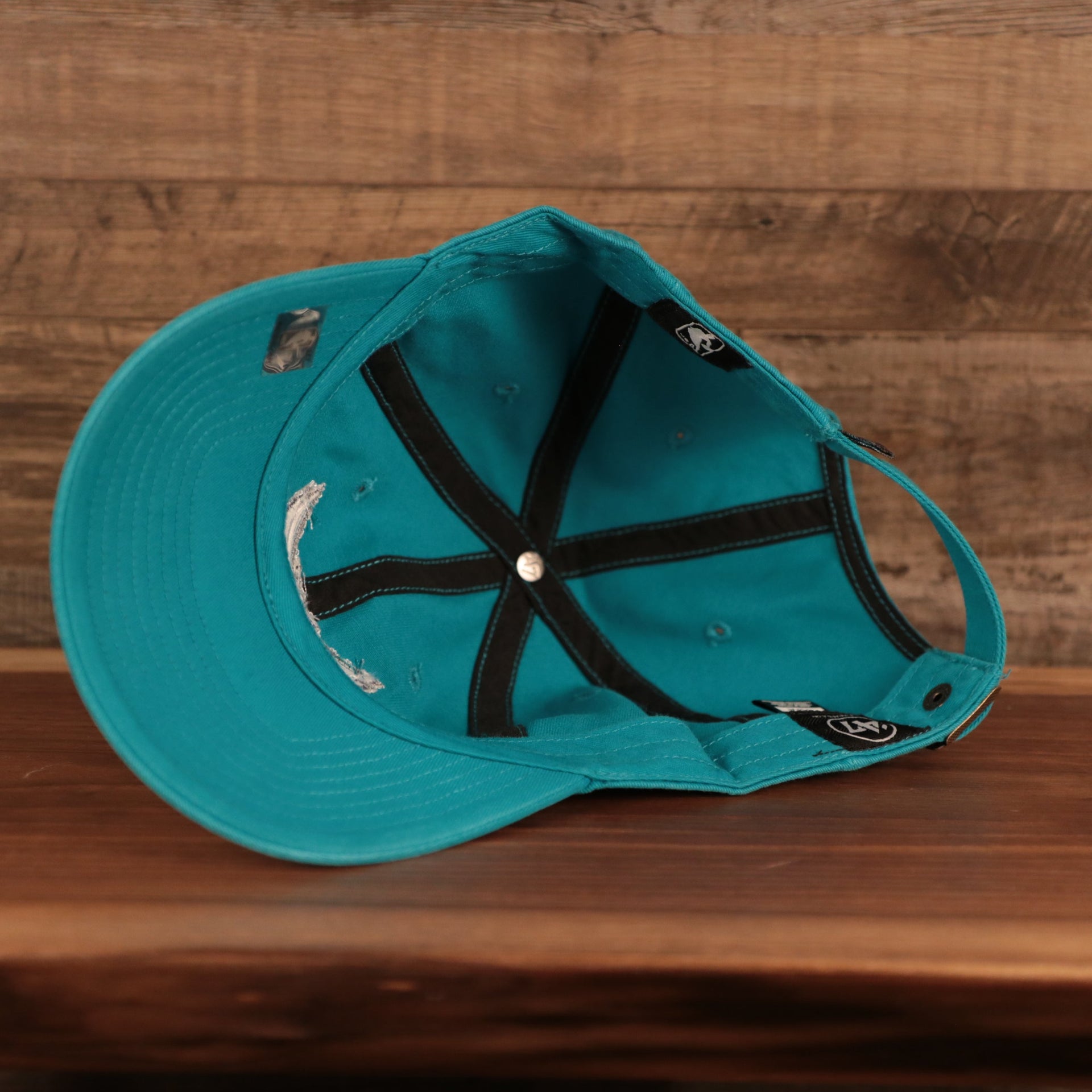 bottom view of the Charlotte Hornets Cyan Adjustable Dad Hat