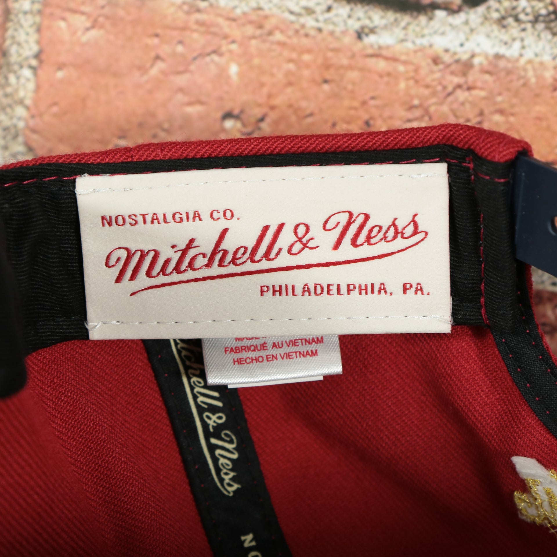 mitchell and ness label on the American Flag Fourth of July Gold Trim Red on Navy Blue Snapback Hat