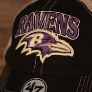 ravens logo on the front of the Baltimore Ravens Black Adjustable Green Bottom Trucker Cap