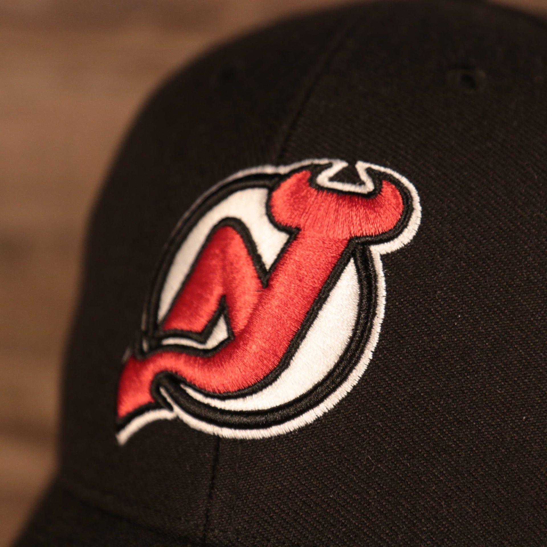 logo on the front of the New Jersey Devils Black Adjustable Dad Hat
