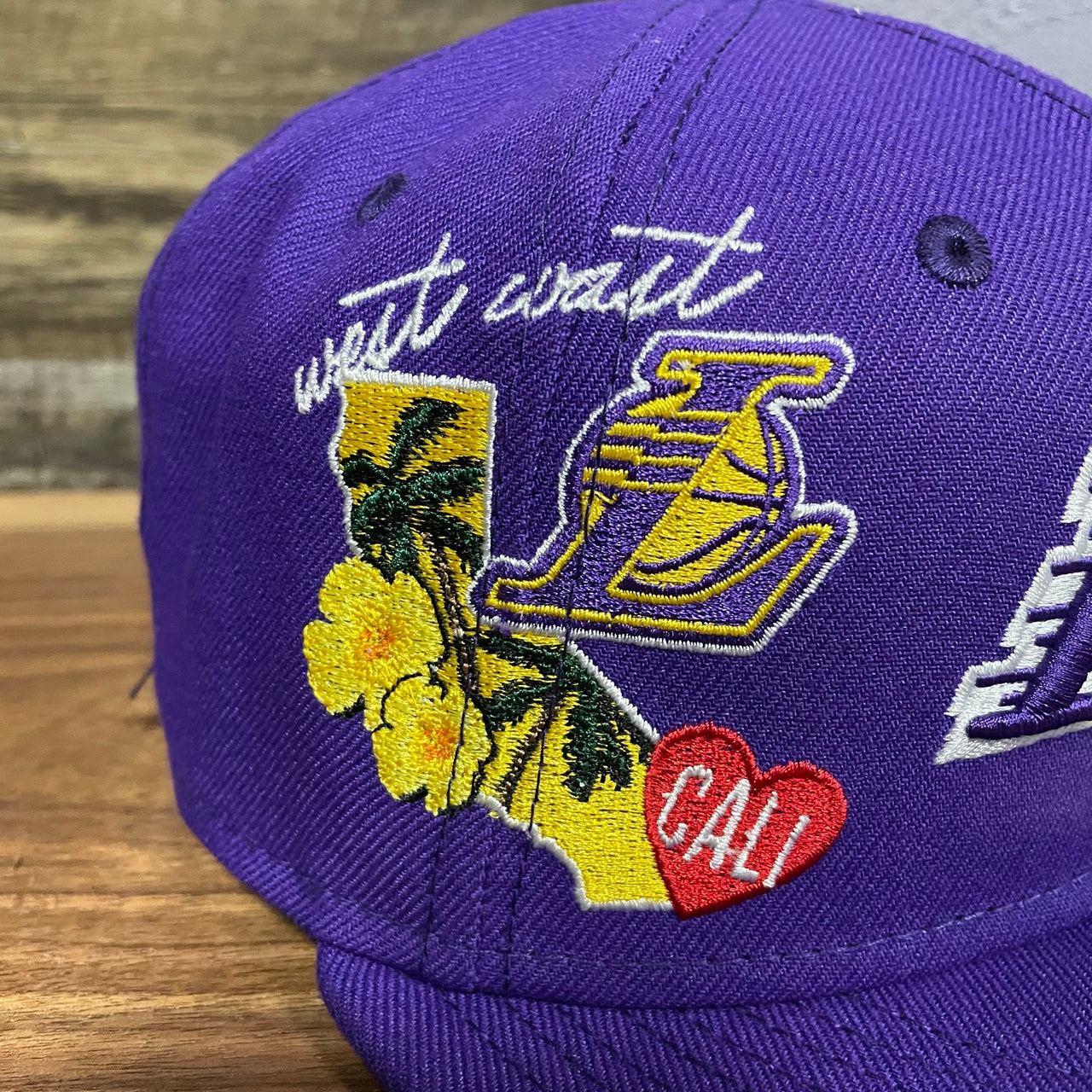 Close up of side patch embroidery on Los Angeles Lakers "City Cluster" Side Patch Gray Bottom Purple 59Fifty Fitted Cap