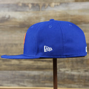 The wearer's left of the New York Mets Gray Bottom Bloom Spring Embroidery 59Fifty Fitted Cap | Royal Blue 59Fifty Cap