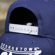 The adjustable strap on the Georgetown Hoyas Team Script Gray Bottom 9Fifty Snapback | Navy Blue And Gray Snap Cap
